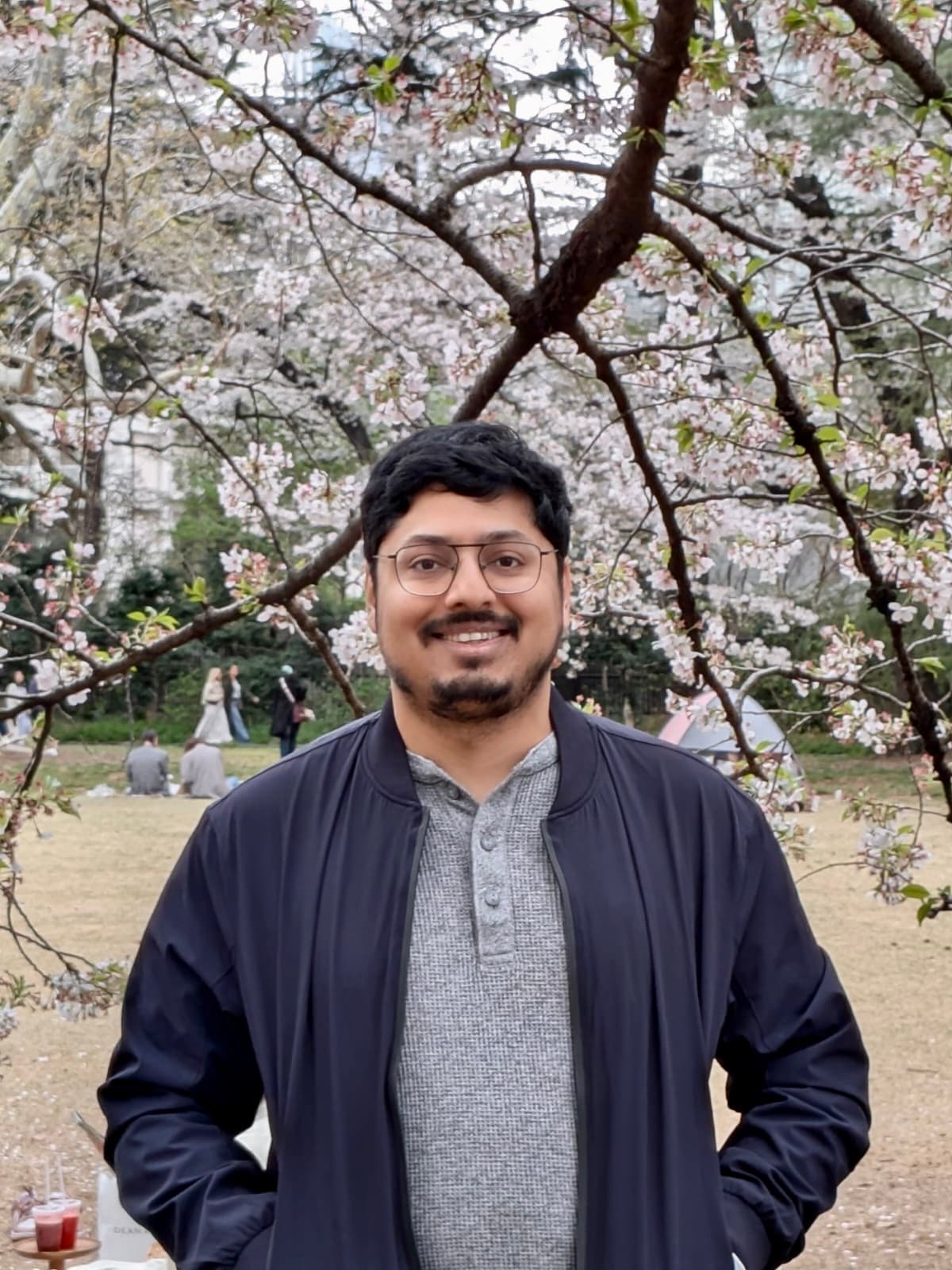 Portrait of Himanshu Dongre under flowering branches.